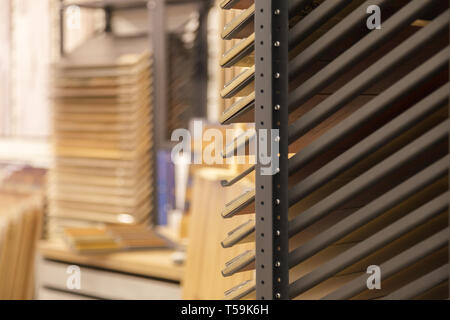 Sample parquet boards in hardware store, in home improvement warehouse exterior. Picture of different colors wooden laminate flooring in shop. Concept Stock Photo