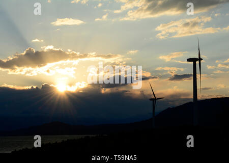 Wind turbines in front of dramatic sunset sky with clouds Stock Photo ...