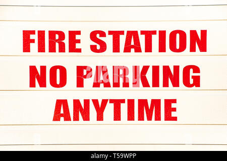 No parking any time sign on a garage door at the Speculator Volunteer Fire Company station in Speculator, NY USA Stock Photo