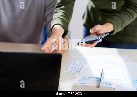 Testing mobile app and discussing mistakes Stock Photo