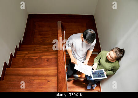 Discussing interface design of application on stairs Stock Photo