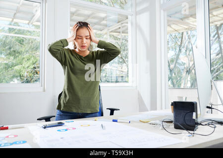 Interface designer having splitting headache Stock Photo