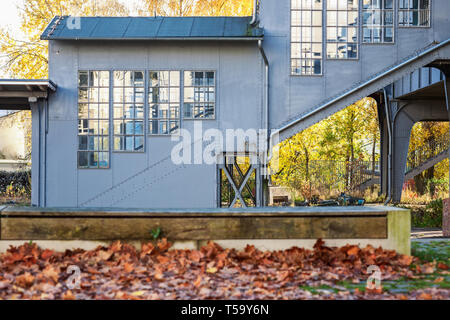 Vintage railway station with wooden bench in foreground, autumn background, germany, solingen Stock Photo