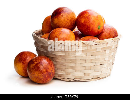 Ripe  red oranges in wicker basket isolated on white Stock Photo