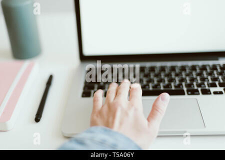 Woman typing at white desk Stock Photo