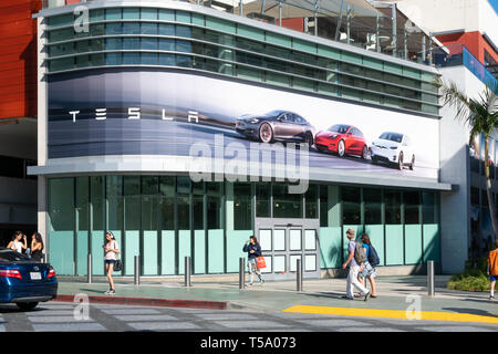 SANTA MONICA, CA/USA - APRIL 18, 2019: Tesla advertisement retail store exterior and unidentified individuals at Third Street Promenade. Stock Photo