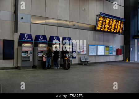 London, United Kingdom - April 15, 2019: Commuters buying tickets from ticket machines located on the concourse below train platforms at London Bridge Stock Photo