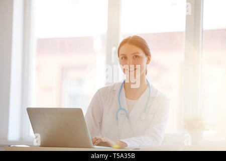 Woman Doctor Posing at Desk Stock Photo