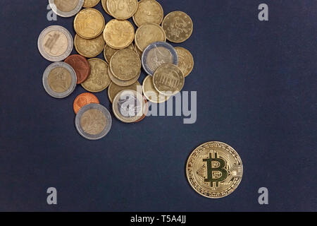Physical version of Bitcoin, new virtual money . Golden symbolic coins of bitcoins on Euro coins. Exchange bitcoin. Concept worldwide cryptocurrency. Stock Photo