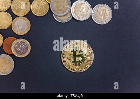 Physical version of Bitcoin, new virtual money . Golden symbolic coins of bitcoins on Euro coins. Exchange bitcoin. Concept worldwide cryptocurrency. Stock Photo