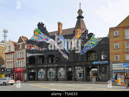 The Ninth Life pub and night club in Catford,South London, UK. Shows the distictive black-painted Victorian elevation with muti-coloured slashes. Stock Photo