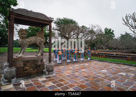 HUE, VIETNAM - January 6, 2019: Vietnamese musicians are playing old traditional music in The Dai Noi Palace or The Palace of the Nguyen. Stock Photo