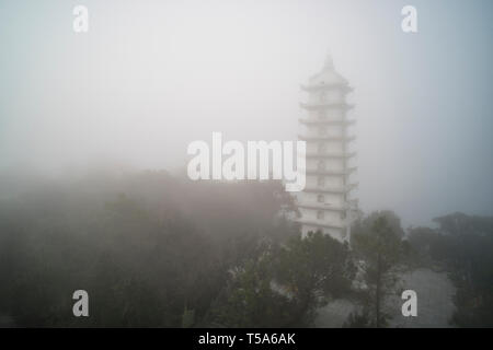 Linh Phong Stupa at Ba Na Hills near Da Nang in Vietnam. Buddhist religious tower in the fog in the mountains of Vietnam. Stock Photo