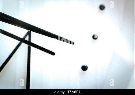 Black Hands on White Clock Face. Light Bulbs Reflections. Time Concept. Stock Photo