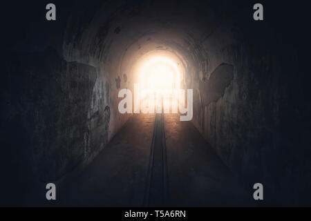 Light in end of tunnel. Long underground concrete corridor in abandoned bunker, toned. Tunnel in underground protective bunker. Protection against nuc Stock Photo
