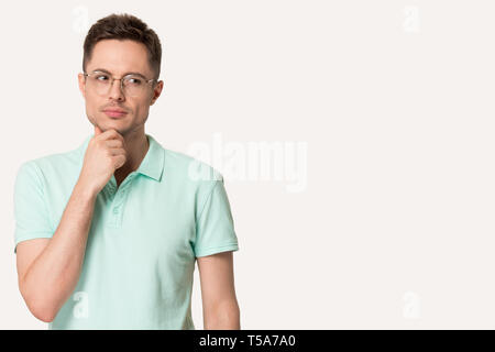 Thoughtful man in glasses touch chin making decision Stock Photo