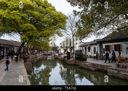 Mar 2017 -Tongli, Jiangsu, China: Tourists walk in the evening along the canals of Tongli, one of the famous water villages not far from Hangzhou and  Stock Photo