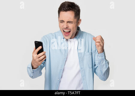 Isolated annoyed Caucasian man scream having cellphone problem Stock Photo