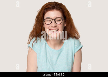 Happy red-haired girl in glasses laugh at funny joke Stock Photo