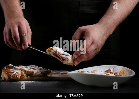 baker decorating on dark background. recipe concept. Stock Photo