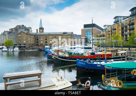 Boats and houseboats moored in St Katherine Dock St Katherines Dock in Wapping in London. Stock Photo