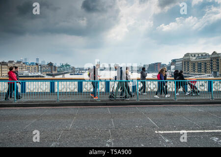 Pedestrians walking over Tower Bridge in London. Stock Photo