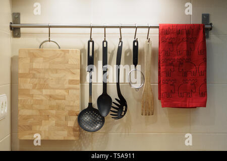 kitchen utensils hanging on the wall Stock Photo