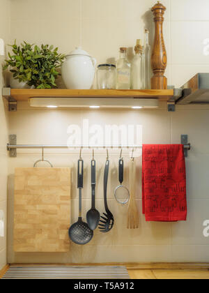 kitchen utensils hanging on the wall. Stock Photo