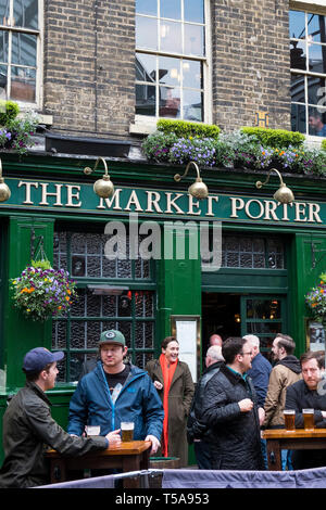 Customers drinking outside the Market Porter public house in Borough Market in London. Stock Photo