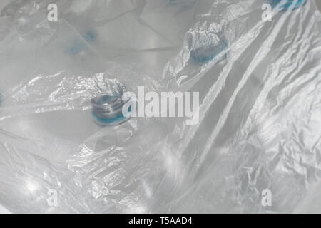 Transparent plastic bag with several empty plastic bottles inside on a white background, and space for inserts.  Reuse, Eco-Friendly, Environment, Con Stock Photo