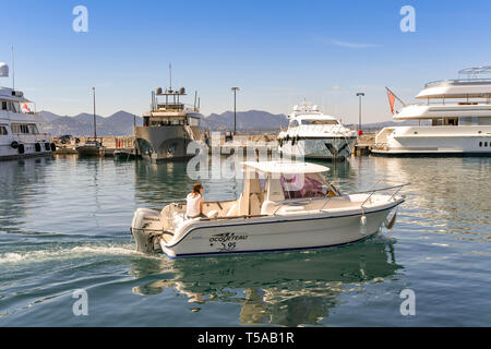CANNES, FRANCE - APRIL 2019: Small boat with outboard motor in the Port Pierre Canto marina in Cannes Stock Photo