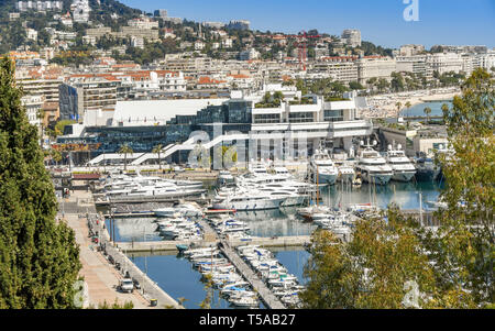CANNES, FRANCE - APRIL 2019: View overlooking the marina in Cannes with the bay in the background. The large building houses a casino. Stock Photo
