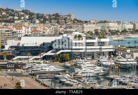 CANNES, FRANCE - APRIL 2019: View overlooking the marina in Cannes with the bay in the background. The large building houses a casino. Stock Photo