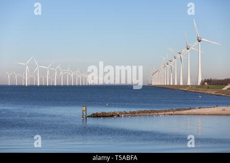 View at off shore wind turbine farm from beach Urk