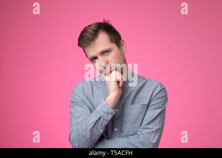 Young caucasian man looking unsatisfied and tired. Stock Photo