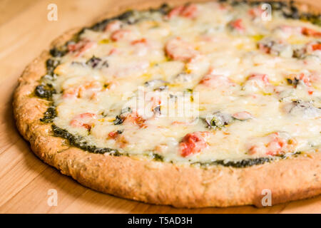 Freshly-baked, vegetarian, pesto, multi-grain, thick-crust pizza. Stock Photo