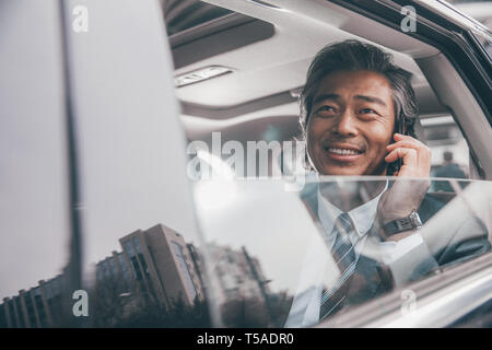 Business men see tablet in the car Stock Photo