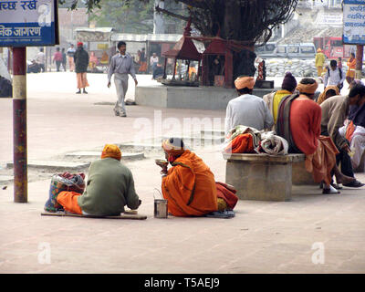 HARIDWAR, India. - DEC-17, 2015: Two men eating food in the pavement on the street. Stock Photo