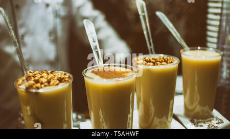 Cups Of Boza (Bosa) Served With Cinnamon And Roasted Chickpeas, Traditional Turkish Hot Drink Stock Photo