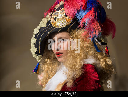Beautiful young woman with blonde curly hair wearing fancy dress costume and hat, Venice carnival portrait, Italy Stock Photo
