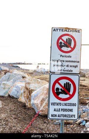 Warning signs reading: 'Warning. Danger submerged reef, rocks on the ...
