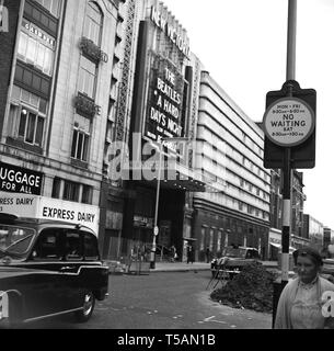 1964, historical, picture shows Wilton Road, London SW1 and The New Victoria Theatre, London which was showing the Beatles film, A Hard Days Night.  Directed by Richard Lester and with a screen play by Alan Owen, the musical comedy featured the 'Fab Four' musicans from Liverpool and actor Wilfrid Brambell - famous for his role in the hit comedy Steptoe and Son - playing Paul McCartney's Grandfather. Stock Photo