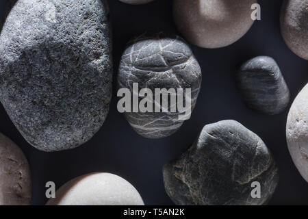 many black stones on the black background , black stone wall texture.hobby, lifestyle Stock Photo