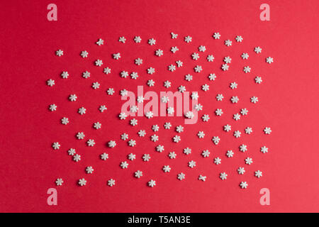 composition of small snowflakes on the red table.top view photo Stock Photo
