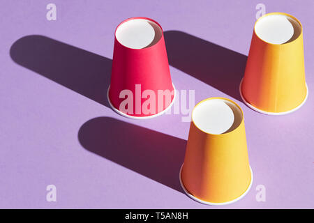 amazing trick with plastic three cups, close up side view photo, entertainment concept Stock Photo