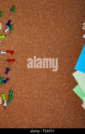 Corkboard with notes. Colored paper on corkboard. Stock Photo