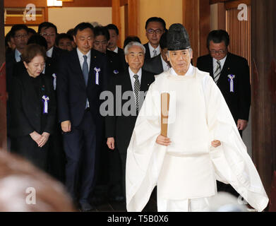 Tokyo, Japan. 23rd Apr, 2019. Japanese lawmakers led by former Health Minister Hidehisa Otsuji (C) follow a Shinto priest (2nd R) during their visit to the controversial Yasukuni shrine to honour the war dead in Tokyo on Tuesday, April 23, 2019. Some 100 Japanese lawmakers and their secretaries paid homage at the controversial shrine for the shrine's spring festival. Credit: Yoshio Tsunoda/AFLO/Alamy Live News Stock Photo