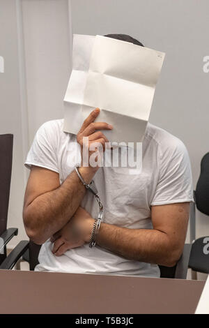 Amberg, Germany. 23rd Apr, 2019. One in four defendants is sitting in the courtroom of the district court. Four young refugees have to answer in court because at the end of last year they allegedly attacked indiscriminately passers-by in the city centre of Amberg. Credit: Armin Weigel/dpa - ATTENTION: person(s) was/are pixelated for legal reasons/dpa/Alamy Live News Stock Photo