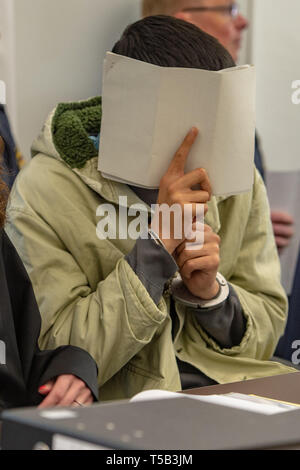 Amberg, Germany. 23rd Apr, 2019. One in four defendants is sitting in the courtroom of the district court. Four young refugees have to answer in court because at the end of last year they allegedly attacked indiscriminately passers-by in the city centre of Amberg. Credit: Armin Weigel/dpa - ATTENTION: person(s) was/are pixelated for legal reasons/dpa/Alamy Live News Stock Photo