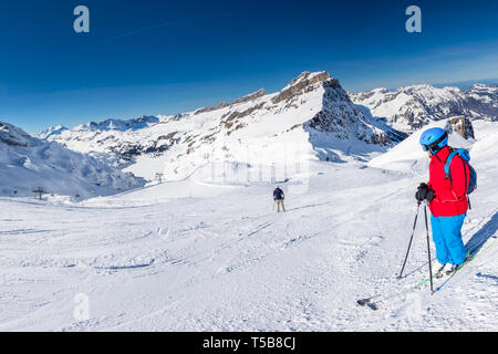 Beautiful winter landscape with Swiss Alps. Skiers skiing in famous Engelgerg - Titlis ski resort, Switzerland, Europe.